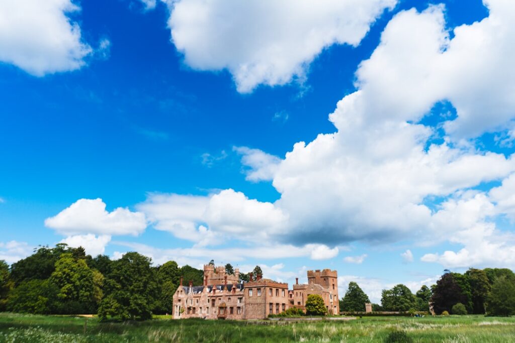 a large building sitting on top of a lush green field
