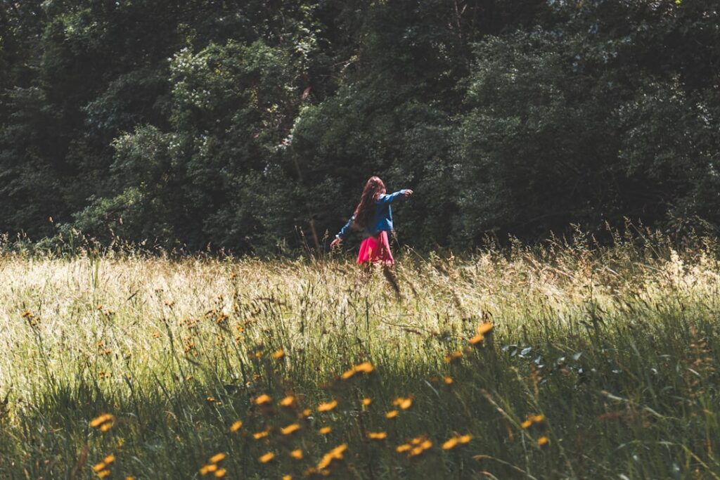 woman standing on green grass field