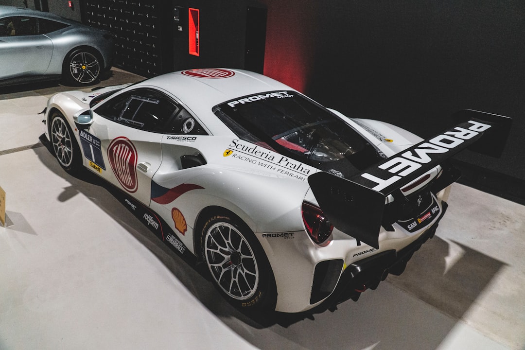 a white sports car is on display in a museum