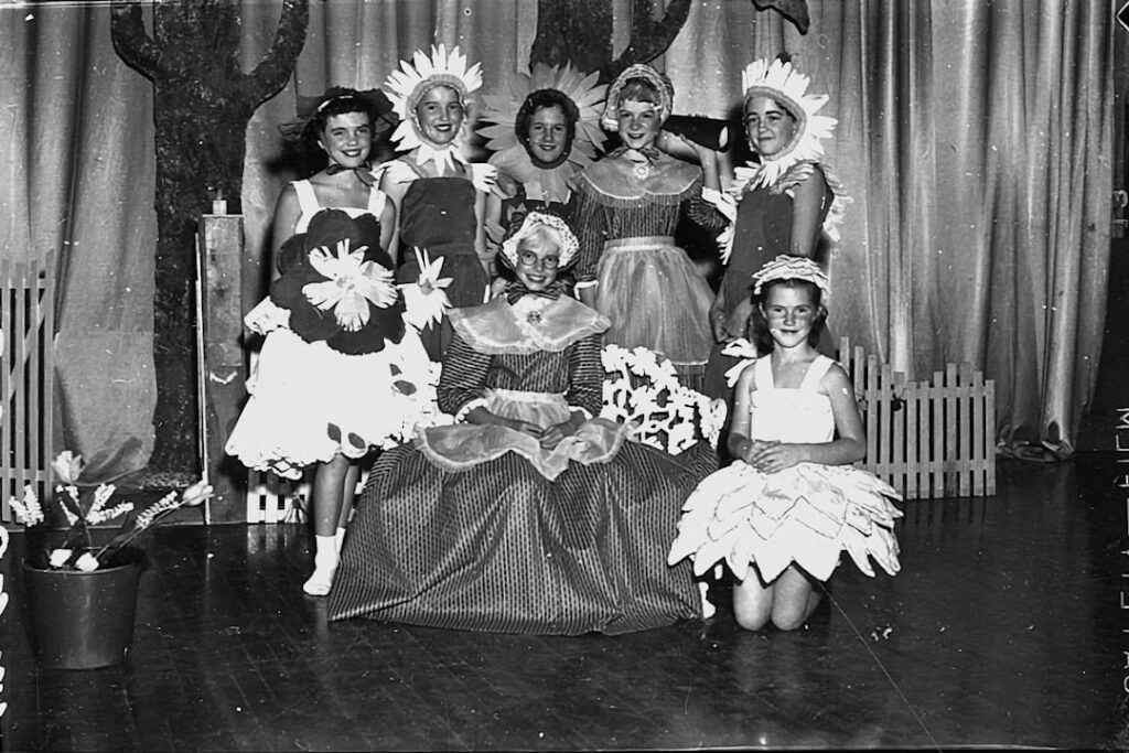 a group of women standing next to each other on a stage