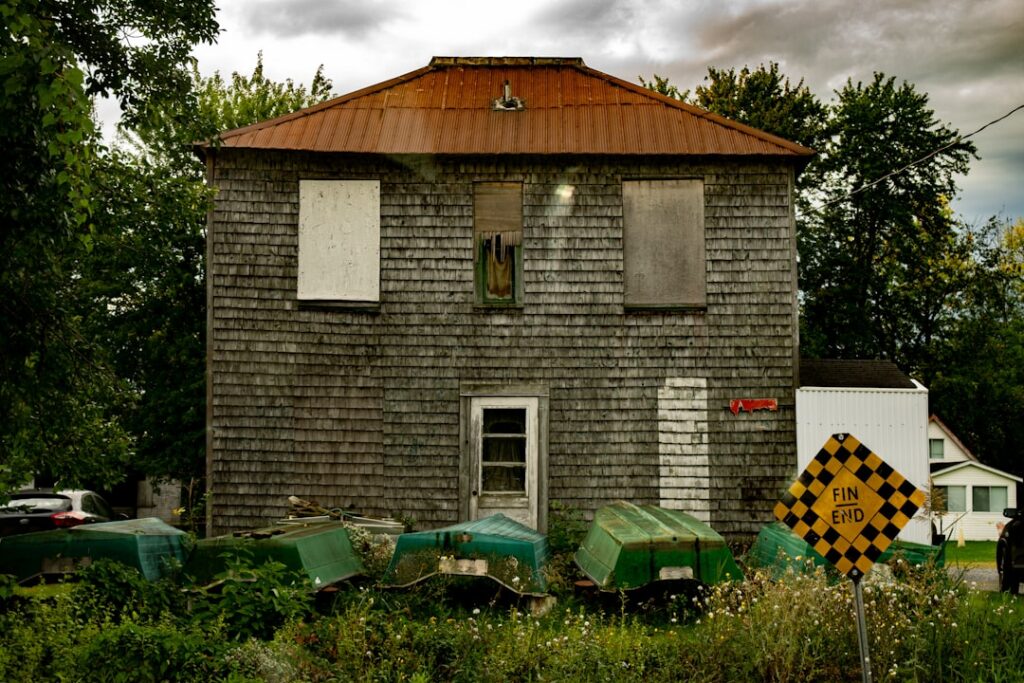 a house with a rusted metal roof and windows