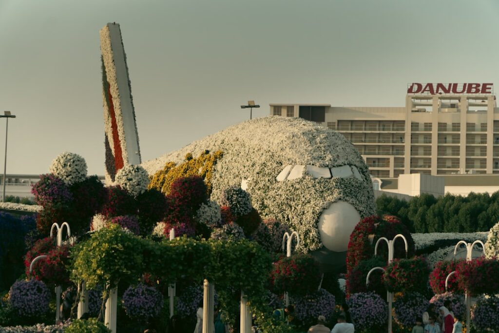 A large building with a lot of flowers in front of it