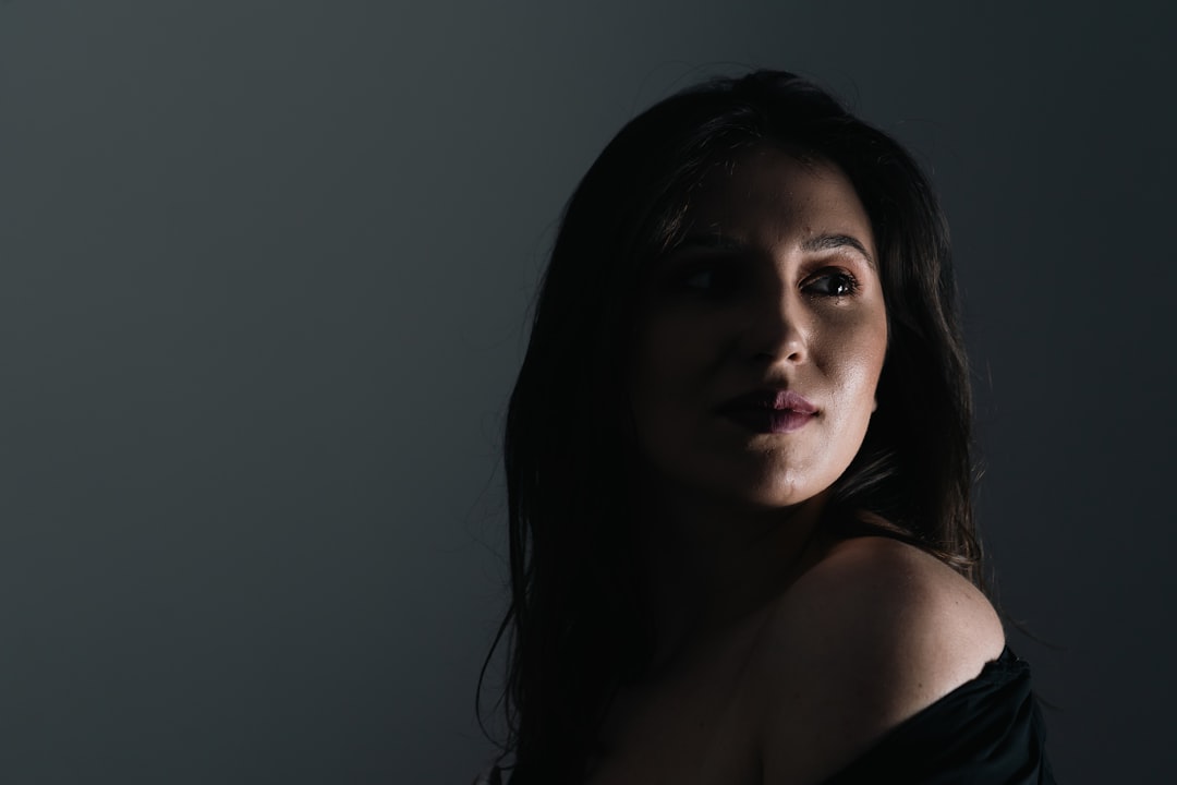 a woman in a black dress posing for a picture