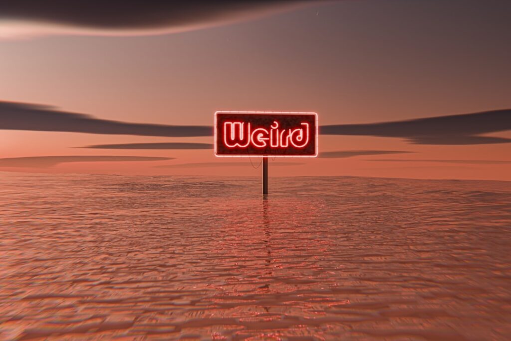 A red sign sitting on top of a sandy beach