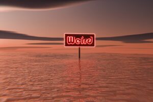 A red sign sitting on top of a sandy beach